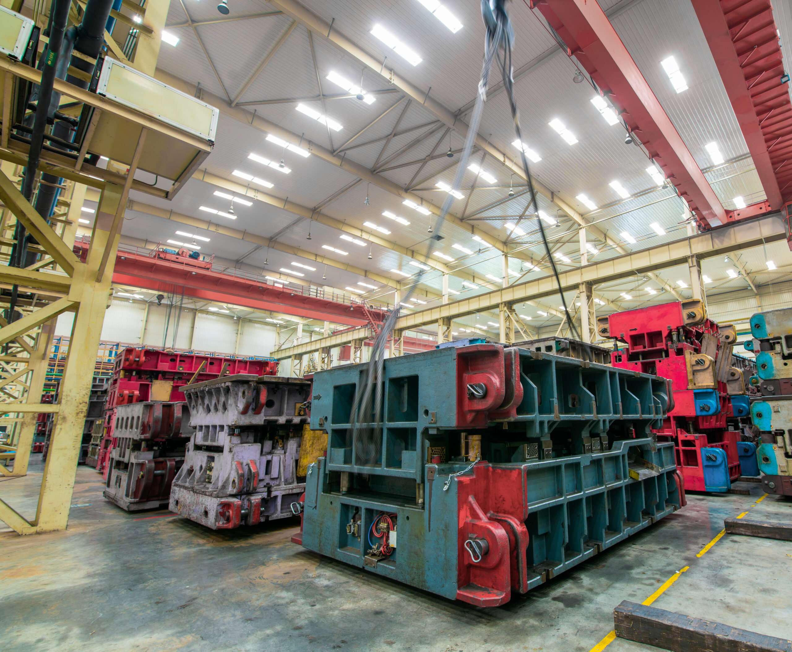 Mold equipment for a car factory in a storage warehouse being lifted by a crane