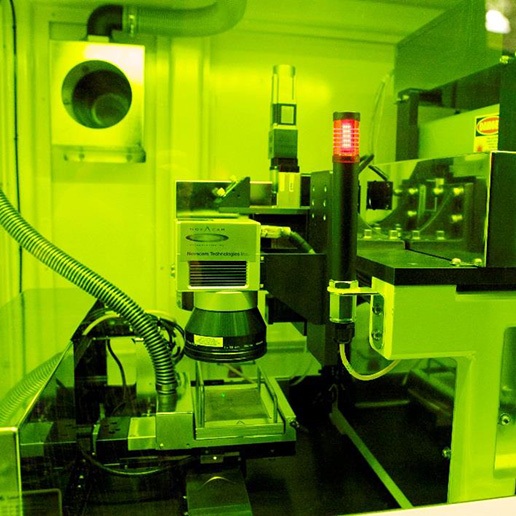 Laser ablation machine with lime green lighting.